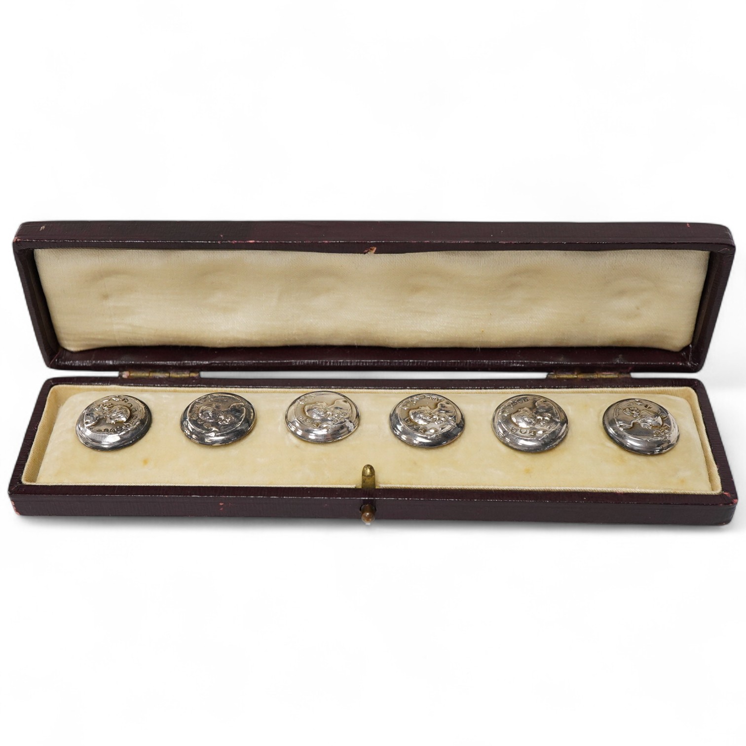 A cased set of six Edwardian small silver buttons, by Turner & Simpson, Chester, 1906, each embossed with the bust of a young lady, diameter 17mm.